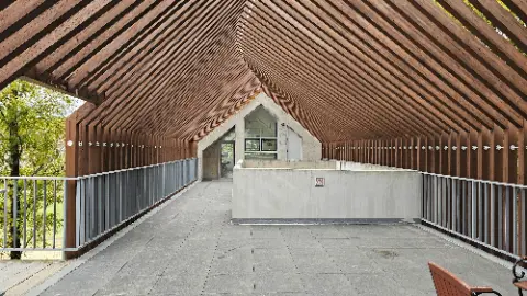 A large building with a wooden roof and a glass