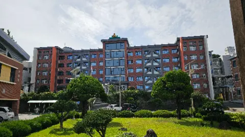 A large building with a yellow roof and a green