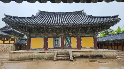 A large building with a yellow roof and a red