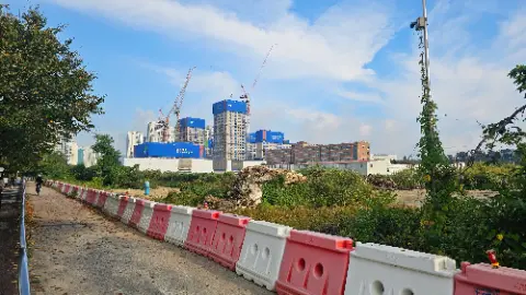A large construction site with a blue building and a