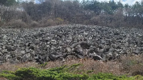 A large pile of rocks on a hillside