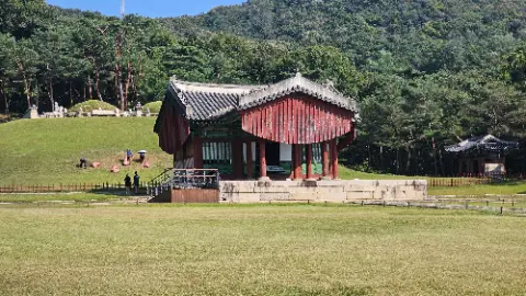 A large red building with a green roof and a