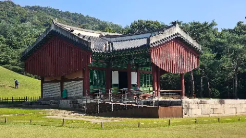 A large red building with green trim and a white