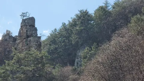 A large rock is on top of a hill with
