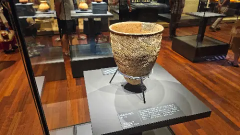 A large vase is on display in a museum