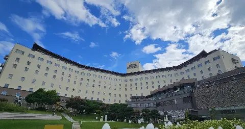A large white building with a blue sky above it
