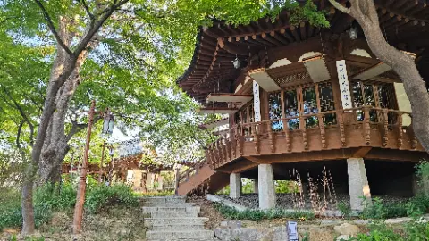A large wooden building with a staircase leading to a