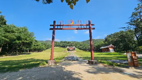 A large wooden structure with a red roof and a