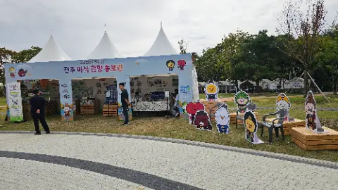 A man is standing in front of a tent with