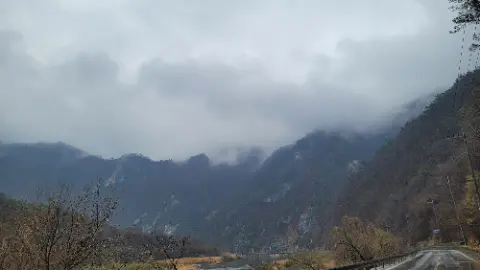 A mountain range with a cloudy sky above it