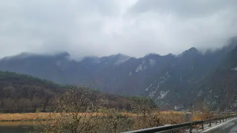 A mountain range with a cloudy sky above