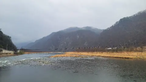 A mountainous area with a river running through it
