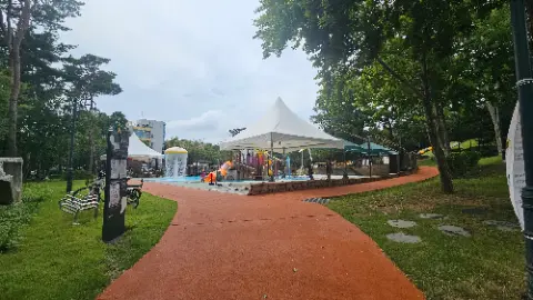 A park with a playground and a water slide