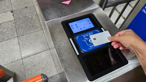 A person is inserting a card into a machine