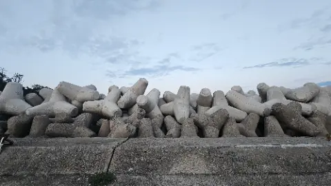A pile of cement blocks are stacked on top of