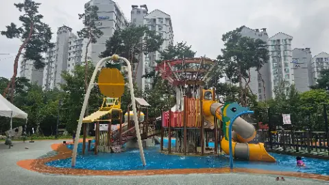 A playground with a slide and a swing in a