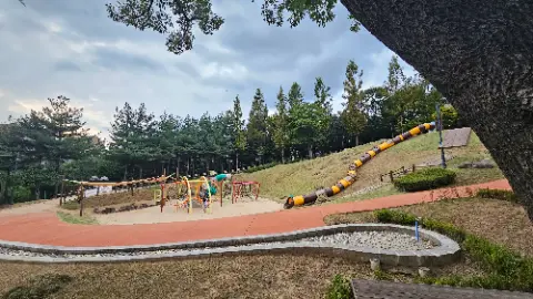 A playground with a slide and a swing set