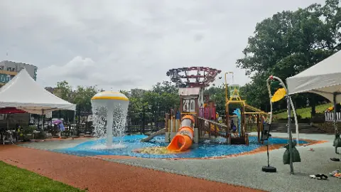A playground with a slide and a water feature