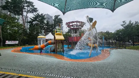 A playground with a water slide and a yellow slide