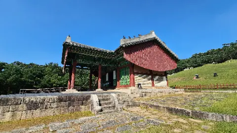 A red and green building with a roof and a