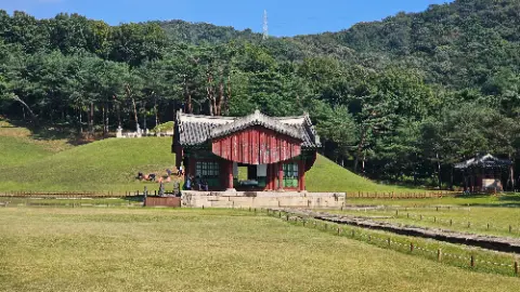 A red and white building with a green roof is