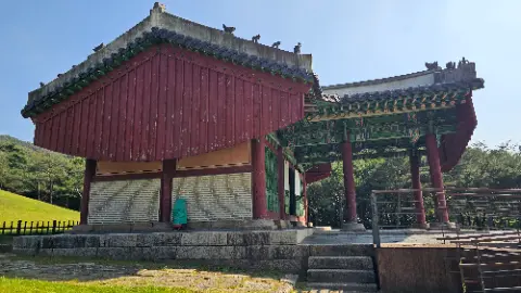 A red building with a green roof and a white