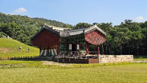 A red building with a green roof and a white