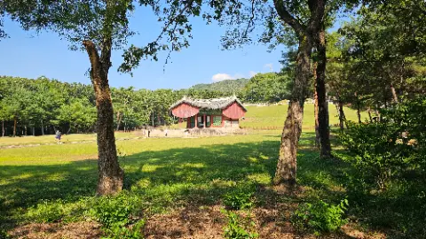 A red building with a white roof is surrounded by