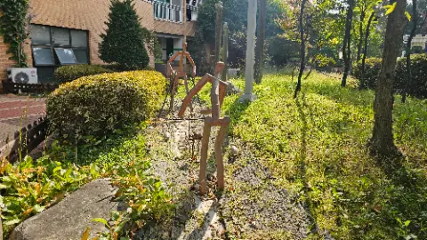 A set of three wooden statues are standing on a