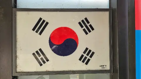A sign with a red circle and blue stripes on