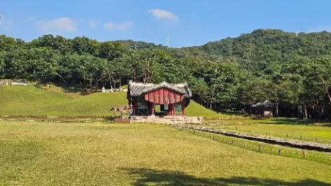A small red building with a white roof is located