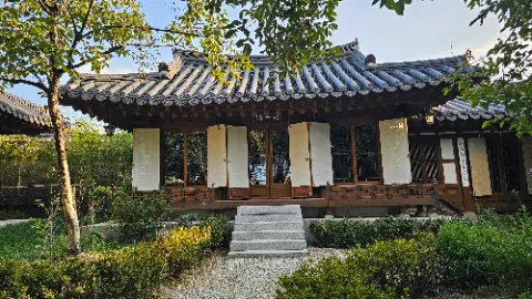A small white house with a thatched roof
