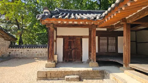 A small wooden building with a thatched roof