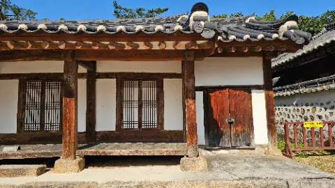 A small wooden house with a white roof