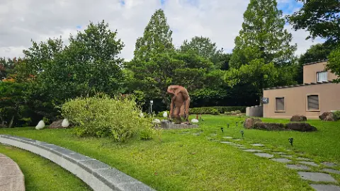 A statue of a man sitting on a rock is
