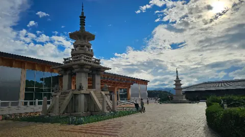 A statue of a pagoda in front of a building