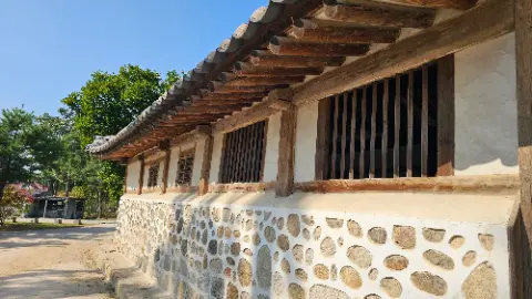 A stone building with a wooden roof