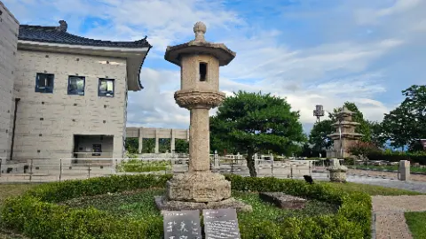 A stone statue with a roof on top of it