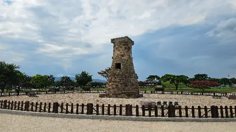 A stone tower with a brick base and a stone