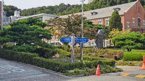 A street sign is on a pole in front of