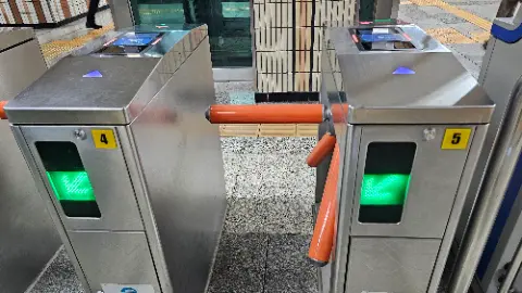 A subway train station with a green light on the