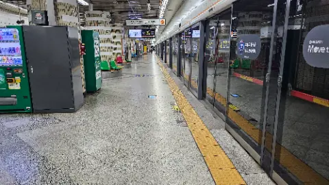 A train station with a train on the tracks