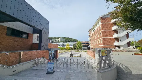 A view of a building with a fence in front