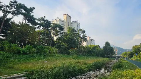 A view of a building with trees in the foreground