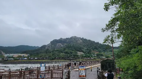 A view of a mountain with a train on the