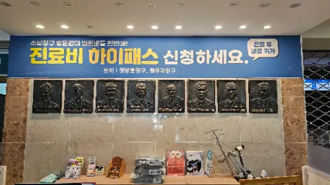 A wall with a row of pictures of men