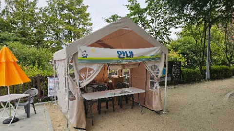 A white tent with a sign on it that says