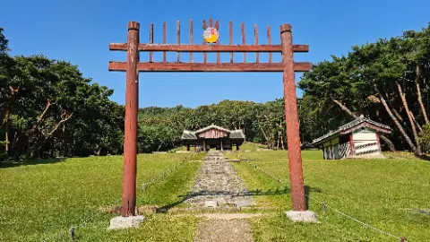 A wooden archway with a sign on top of it
