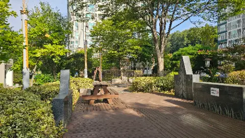 A wooden bench is situated in a park with a