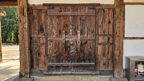 A wooden door with a large wooden frame